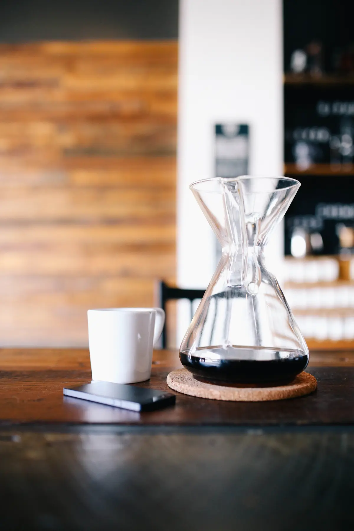Coffee, notebook, and camera on a wooden table